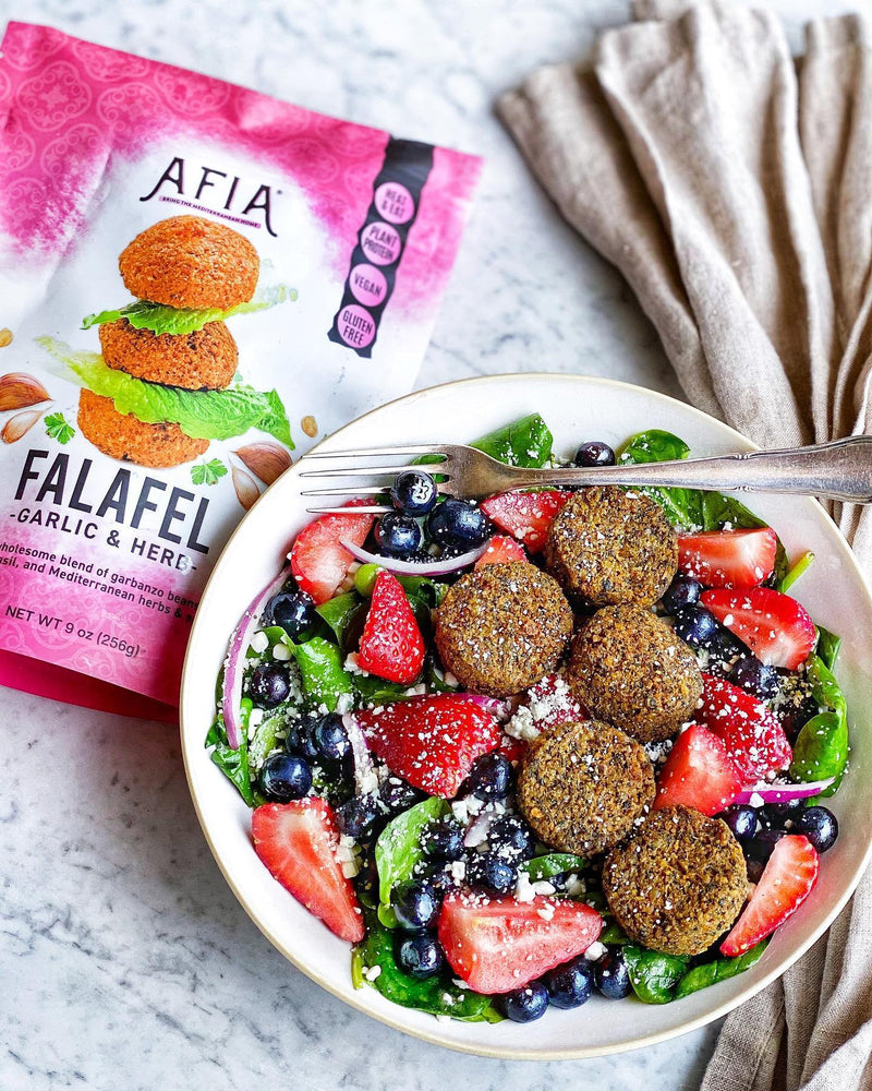 Summer salad with berries featuring Afia Falafel