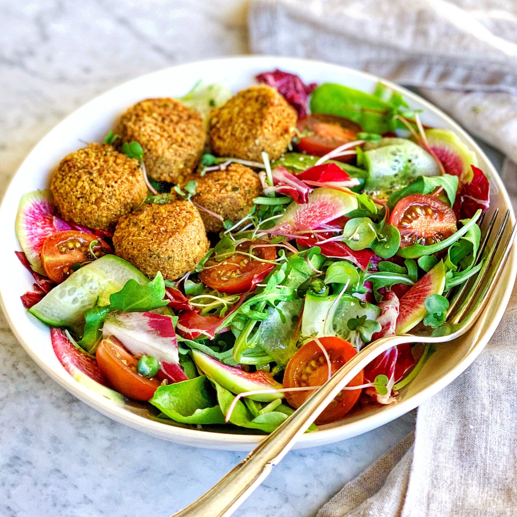Salad with greens and fresh vegetables featuring Afia Falafel 