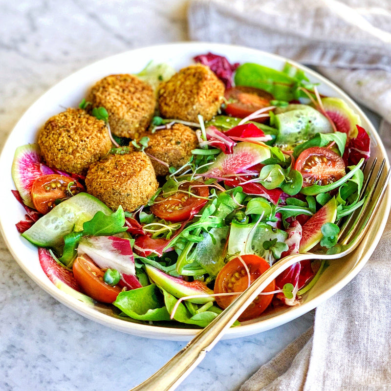 Salad with greens and fresh vegetables featuring Afia Falafel 