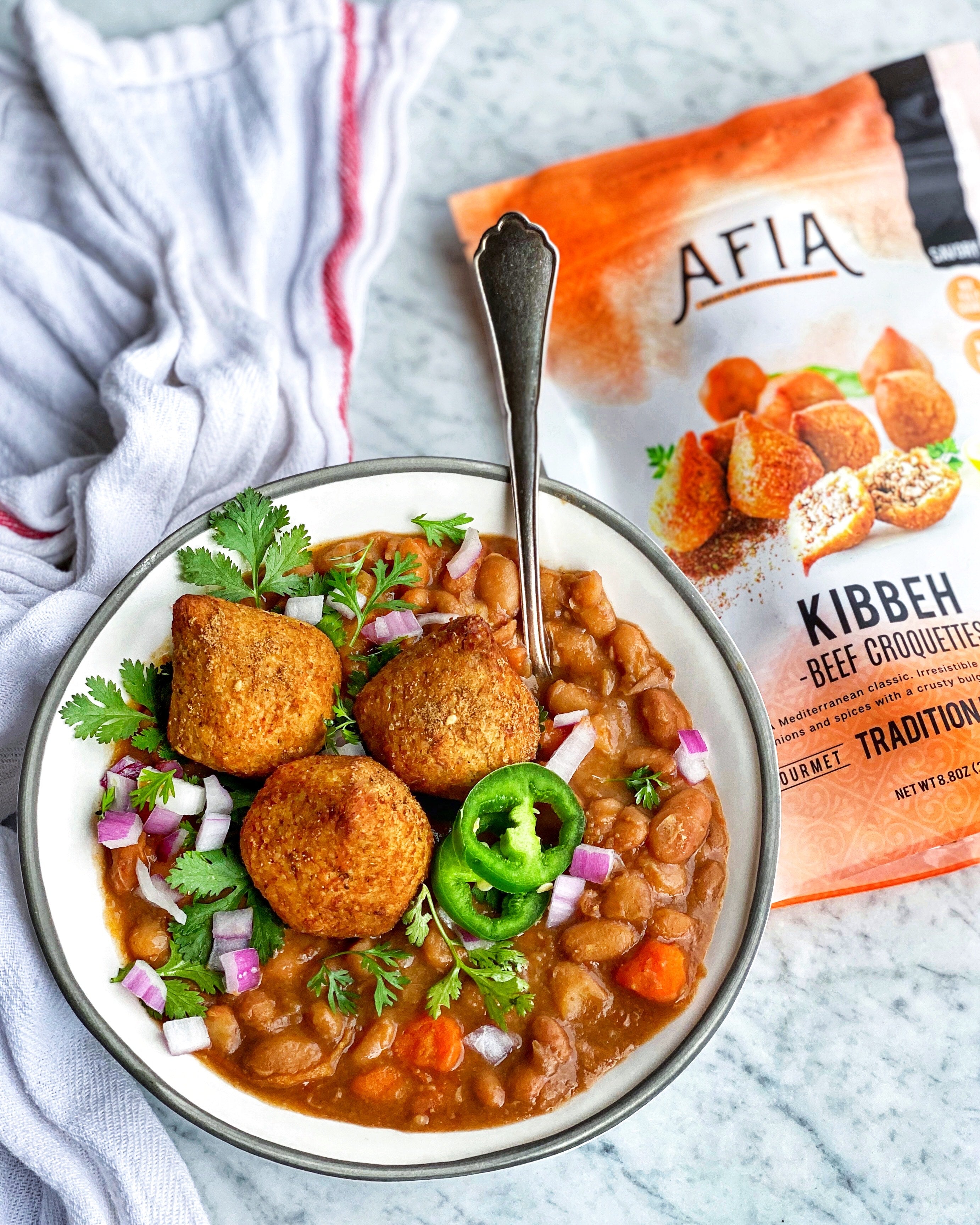 Pinto bean soup in a bowl featuring Afia Kibbeh.