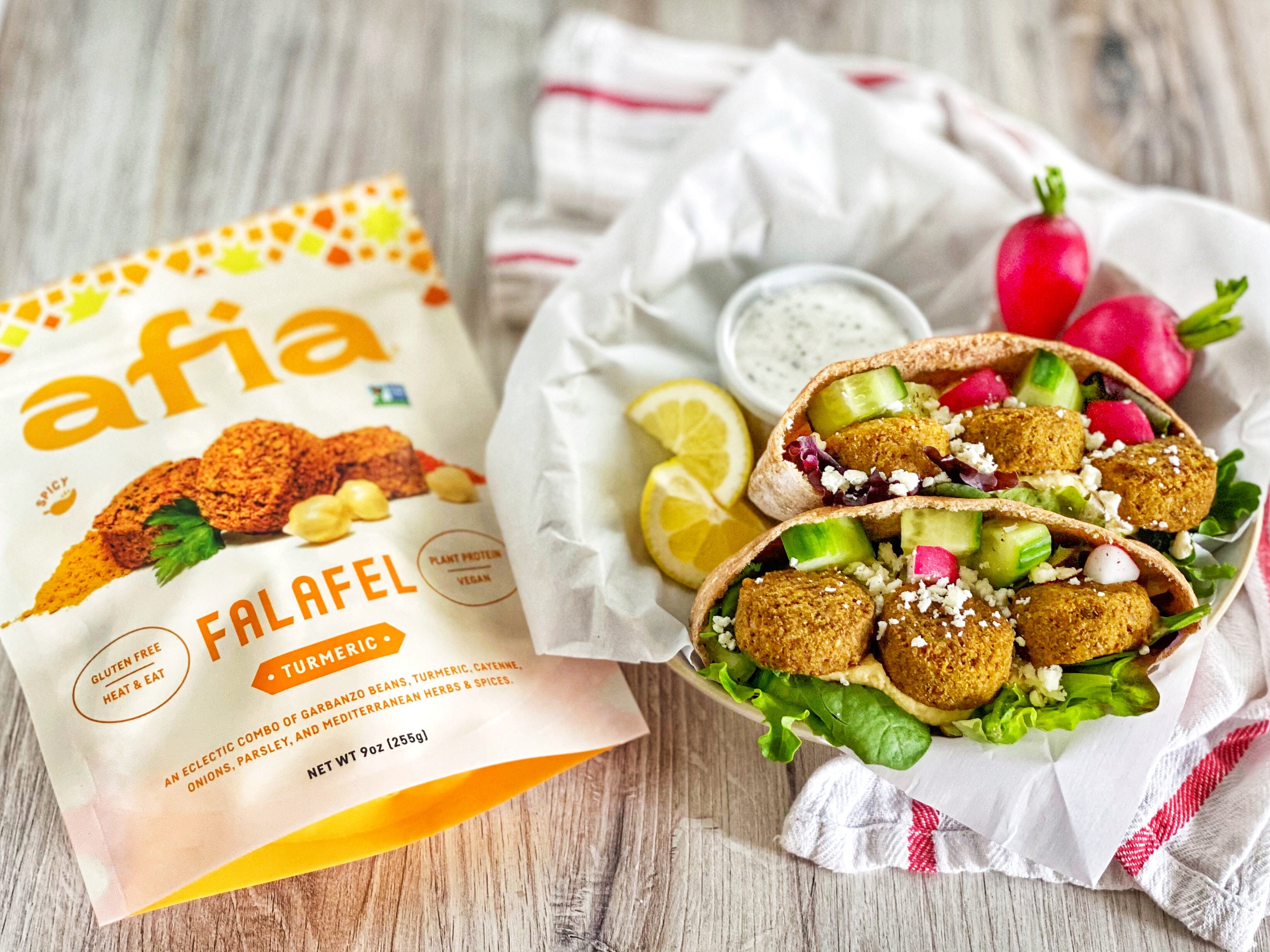 Turmeric Falafel Pita next to a bag of Afia Falafel