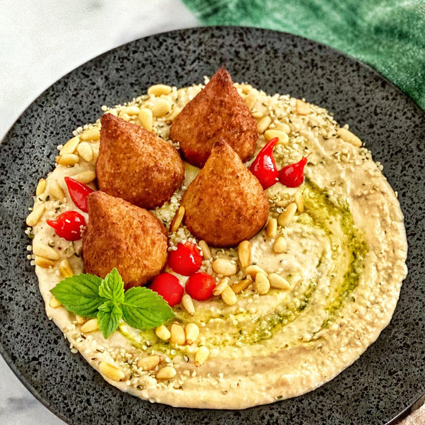Hummus featuring Afia Beef Croquette Kibbeh. 