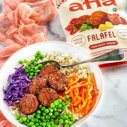 Grain bowl with fresh vegetables and Afia Sun-Dried Tomato Falafel on top.